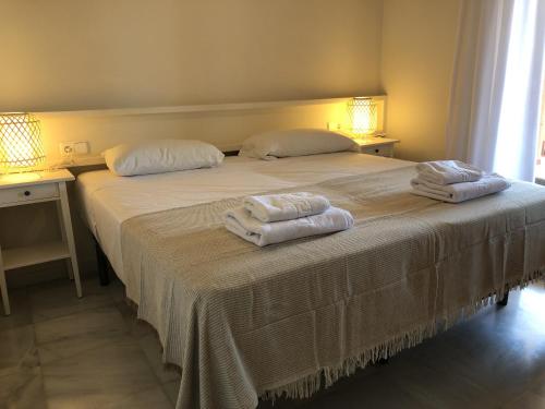 a bedroom with a large bed with towels on it at La Cala Azul 2 bedroom apartment with big sunny terrace & walking distance to all the amenities - costa del sol in La Cala de Mijas