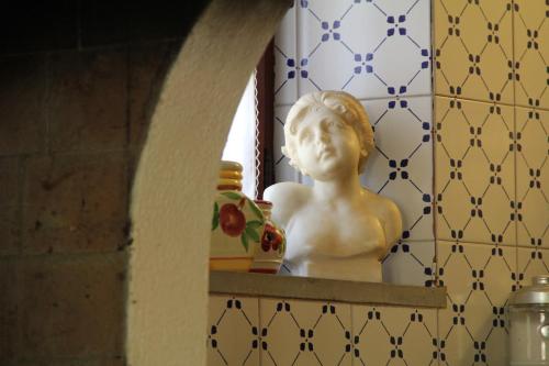 a statue of a bust on a shelf in a room at Villa Veralda, la magia di una Toscana insolita in Fivizzano