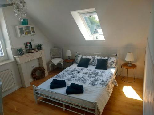 a bedroom with a bed with blue pillows on it at Luana`s White Cottage in Surwold