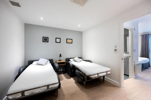 two beds in a room with a mirror at Staycity Aparthotels Birmingham City Centre in Birmingham