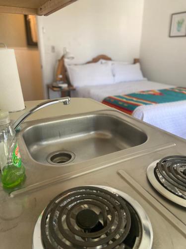 a kitchen counter with a sink and a stove at The Summit Inn in Cloudcroft