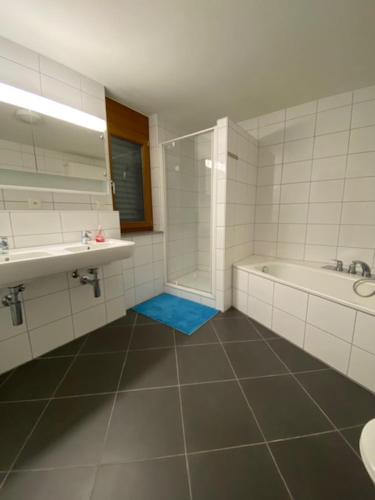 a bathroom with a shower and a tub and a sink at Maisonette im Penthouse-Stil ca 145m2 mit viel Privatsphäre - direkt am Walensee mit Badestrand in Unterterzen