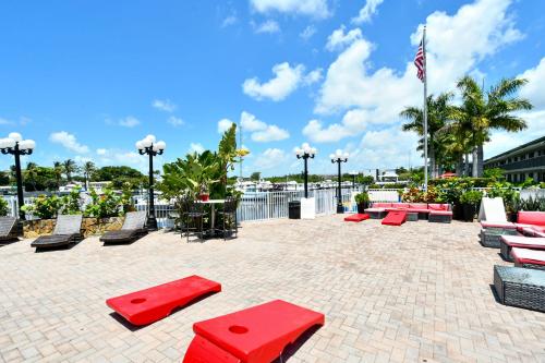 a group of red benches on a brick patio at Remodeled, Huge Pool, Tiki Bar & Grill, Quiet Room in Sarasota