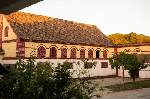 ein großes Backsteingebäude mit braunem Dach in der Unterkunft Salaš 318 - B&B Farm Experience in Drenovac