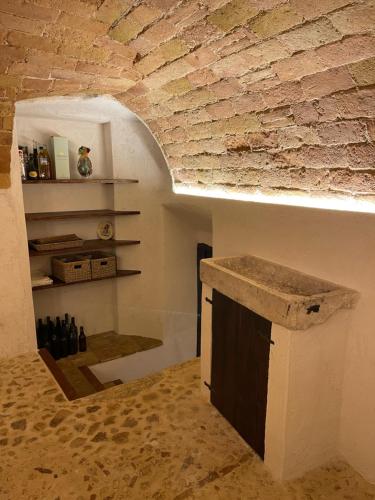 a kitchen with a counter and a brick wall at La casa di mezzo in Calascio