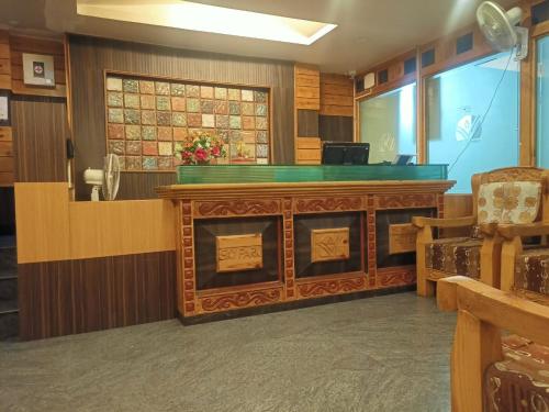 a waiting room with a wooden podium in a courtroom at SKY PARK HOTELS in Tiruppūr