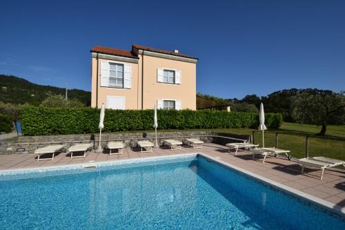 a villa with a swimming pool in front of a house at Case Vacanze Malonghe in Deiva Marina