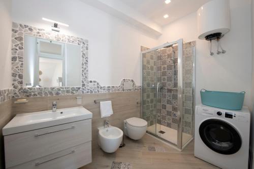 a bathroom with a sink and a washing machine at Amalfi Venere house -balcony & seaview in Amalfi
