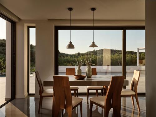 a dining room with a table and chairs at Drallos Luxury Villa - Private Heated Pool & Large Groups, by ZanteWize in Alikanas