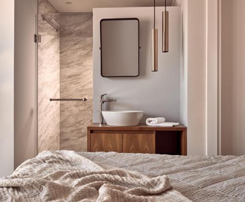 a bedroom with a sink and a mirror at Drallos Luxury Villa - Private Heated Pool & Large Groups, by ZanteWize in Alikanas