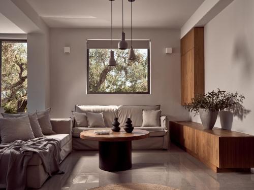 a living room with a couch and a table at Drallos Luxury Villa - Private Heated Pool & Large Groups, by ZanteWize in Alikanas