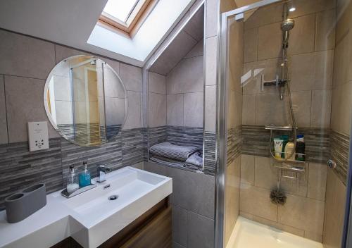 a bathroom with a sink and a shower and a mirror at Modern Apartment Sherburn In Elmet in Sherburn in Elmet