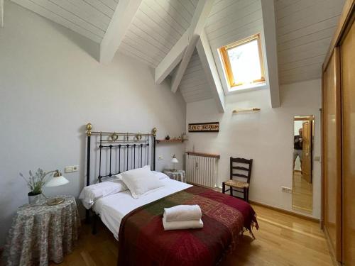 a bedroom with a bed with two towels on it at Apartamento Pico de Alba in Benasque