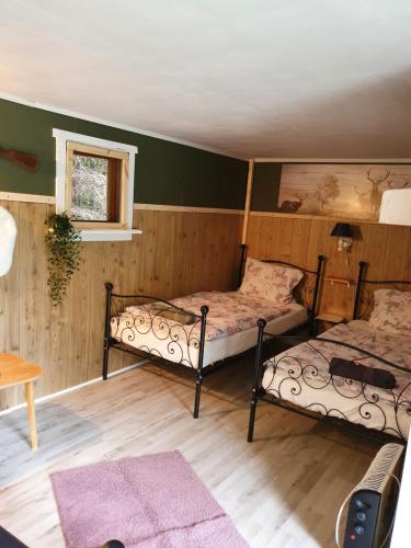 Cette chambre comprend 2 lits et une fenêtre. dans l'établissement Schnieder's Stuga, à Harmånger