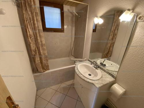 a small bathroom with a sink and a bath tub at Appartement Les Angles, 3 pièces, 6 personnes - FR-1-295-157 in Les Angles