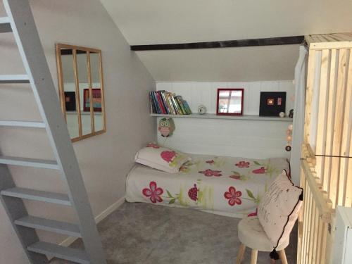 ein Kinderschlafzimmer mit einem Bett und einer Treppe in der Unterkunft Gîte chaleureux au lac de Payolle in Campan