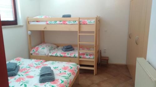 a bedroom with two bunk beds and a bed at Apartma Lara in Bled