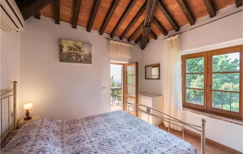 una camera con un letto in una stanza con finestre di La Casina Del Melograno a Civitella Marittima