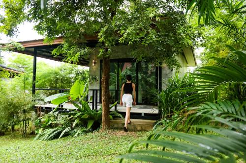 a person walking out of a small house at Annie Meen's place Koh Yao Noi in Ko Yao Noi