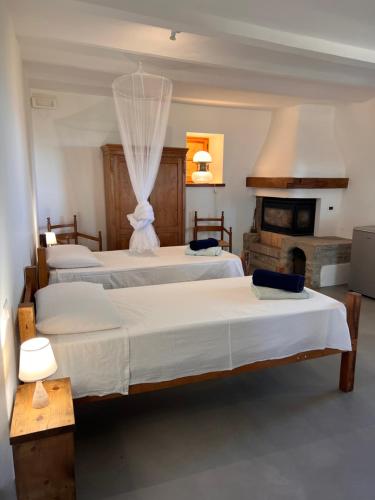 a bedroom with four beds and a fireplace at Agriturismo Sanventura in Città di Castello