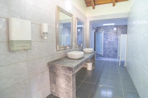 a bathroom with two sinks and a mirror at Santorini Villas del Mar Santa Marta in Santa Marta