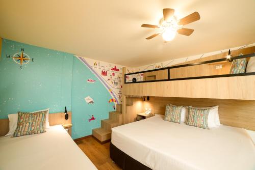 a bedroom with two beds and a ceiling fan at Centro by Casa Andina Miraflores in Lima