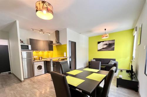 une cuisine et une salle à manger avec une table et des chaises dans l'établissement Esprit libre, Beau 2 pièces climatisé, à Bordeaux