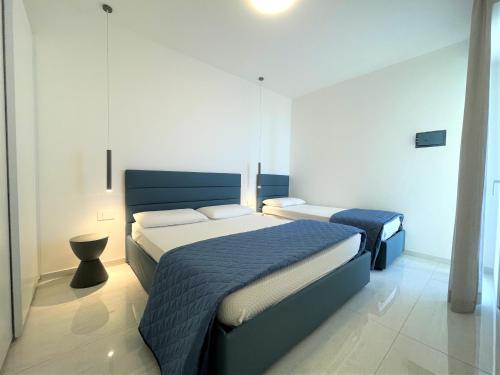 En eller flere senge i et værelse på Condominio Girasole