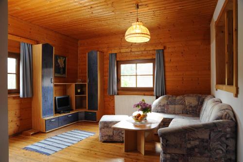 a living room with a couch and a table at Ferienhof Haberzettl 