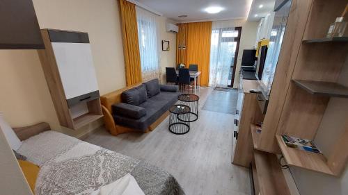 a living room with a bed and a couch at Sunrise City A2, Sarafovo in Burgas