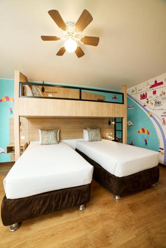 two beds in a room with a ceiling fan at Centro by Casa Andina Miraflores in Lima