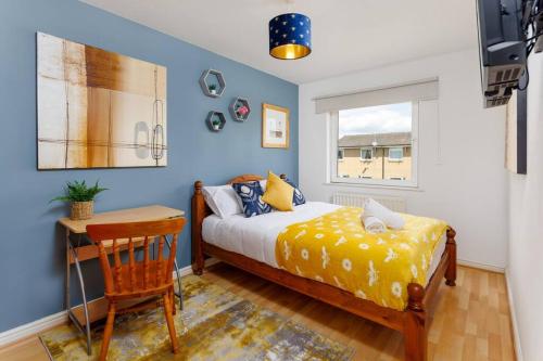 a bedroom with a bed and a desk and a window at Sunshine Terrace by Happy Sunshine Stay in Manchester