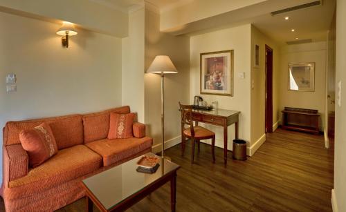a living room with a couch and a table at Volos Palace in Volos