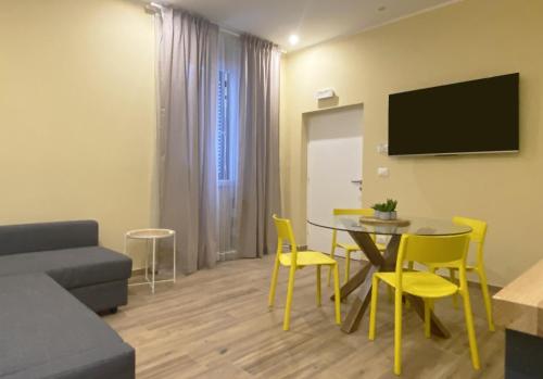 a living room with a couch and a table and chairs at Sami B&B and holidays home in Taranto