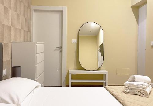 a bedroom with a bed and a mirror on the wall at Sami B&B and holidays home in Taranto