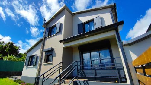 a house with a blue sky in the background at Les Villas KAZEN in La Plaine des Cafres