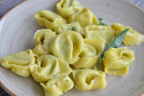 a white plate of pasta on a table at Il Mandriano in Carpegna