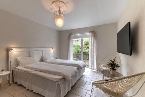 a bedroom with a large bed and a window at visitHOMES Faroe Islands in Leirv&iacute;k