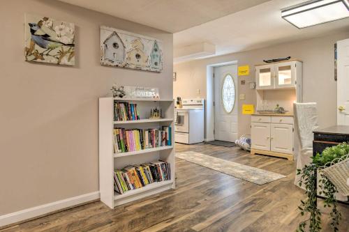 a living room with a book shelf filled with books at Bel Air Apartment with Pool about 2 Mi to Main St in Bel Air