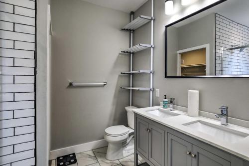 a bathroom with a sink and a toilet and a mirror at Well-Appointed Pittsburgh Home 1 Mi to Dtwn! in Pittsburgh