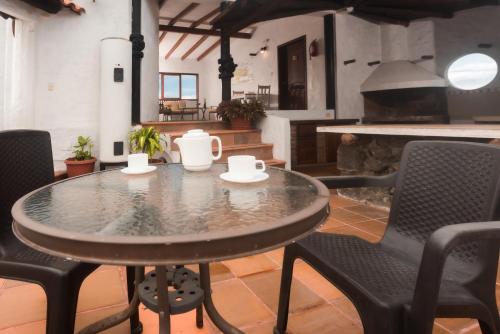 a table and chairs in a room with a fireplace at Hostal North Seymour in Puerto Ayora