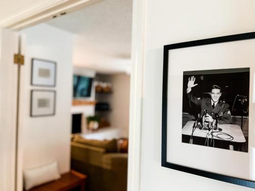 a picture of a man sitting on a table in a living room at The Mini Mansion at Graceland in Memphis