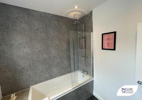 a bathroom with a shower and a bath tub at Luke Stays - Pembroke Avenue in Walker Gate