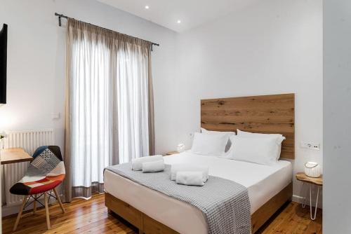sypialnia z dużym łóżkiem z drewnianym zagłówkiem w obiekcie BEAUTIFUL ΝΕW CENTRAL APPARTMENT w Atenach