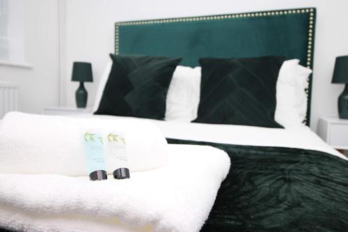 a bed with black and white sheets and black pillows at 2 Bedroom House on Holmes Hill Road- Free Parking, Wi-Fi & Patio in Bristol