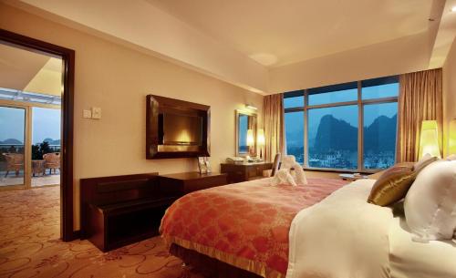 Postel nebo postele na pokoji v ubytování Lijiang Waterfall Hotel Guilin