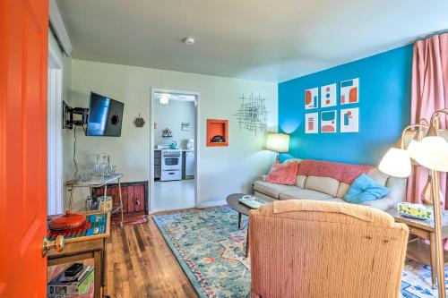 a living room with blue walls and a couch at Modern Rapid City Duplex Less Than 10 Mi to Natl Forest! in Rapid City