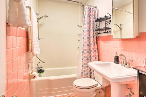 a pink bathroom with a sink and a toilet at Rapid City Duplex Less Than 10 Mi to Natl Forest! in Rapid City