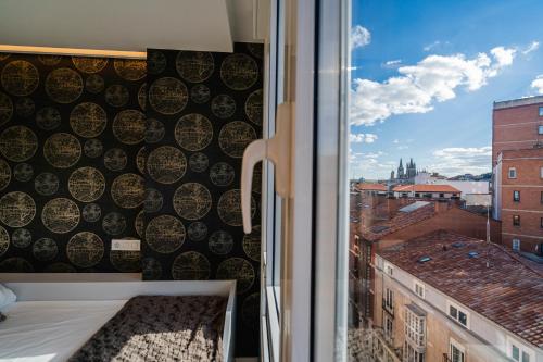 a window with a view of a city at Cid Campeador I - Apartamentos Burgos Deluxe in Burgos