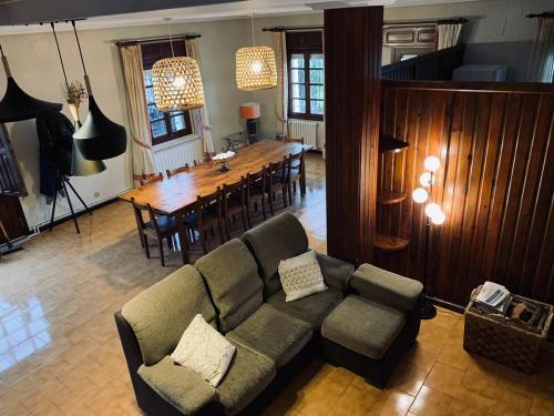 a living room with a couch and a dining table at Casa en Cambeo in Ourense